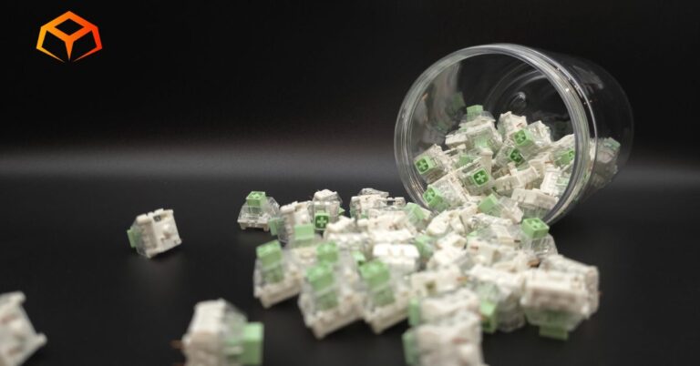 Close up shot of Kailh Box Jade switches spilling from a jar