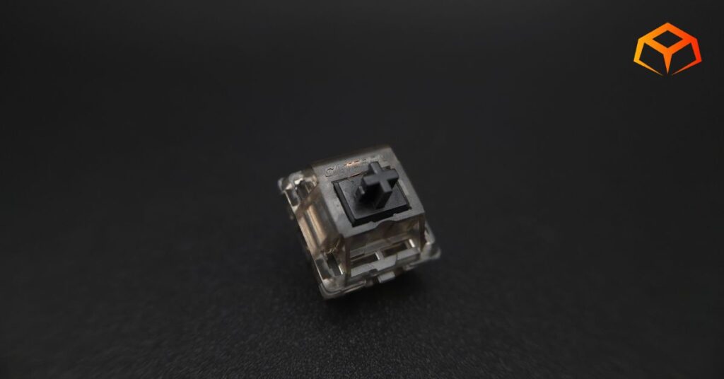 Macro shot of a single Gateron Ink Black switch with emphasis on the logo