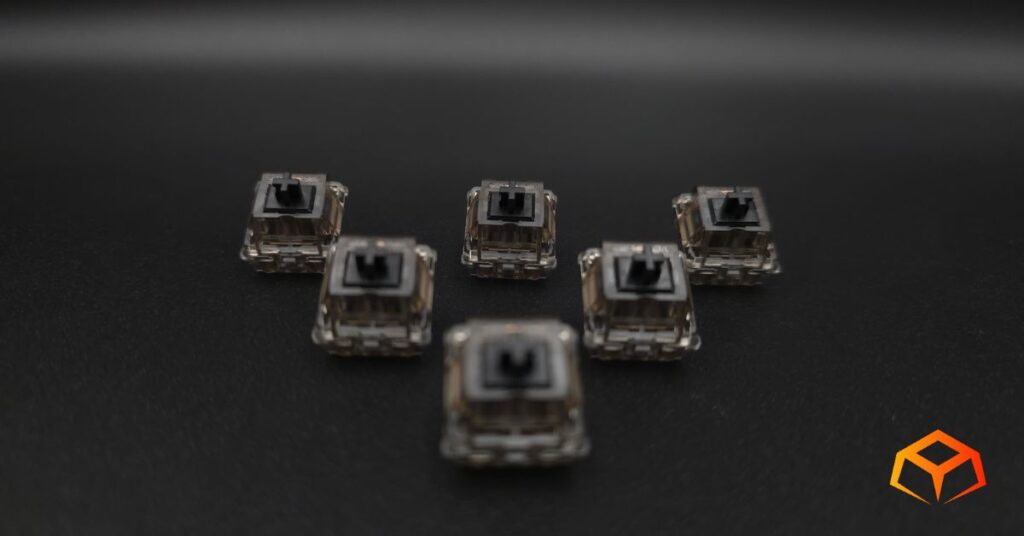 Macro shot of Gateron Ink Black switches arranged in a triangle formation