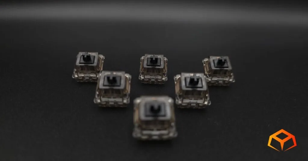 Macro shot of Gateron Ink Black switches arranged in a triangle formation