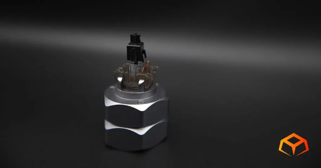 Macro shot of a Gateron Ink Black switch without the top housing, exposing the stem, spring, and leaf