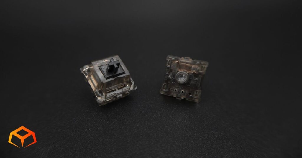 Macro shot of two Gateron Ink Black switches side-by-side with one showing its top and the other showing its bottom