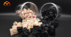 Close up shot of Gateron Cream Soda and Gateron Oil King Switches spilling from jars