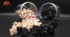 Close up shot of Gateron Cream Soda and Gateron Oil King Switches spilling from jars