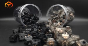 Close up shot of Gateron Oil King and Gateron Ink Black switches spilling out of jars