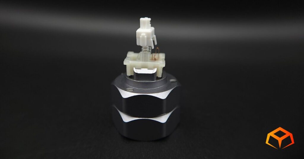 KTT Kang White linear switch without top housing with stem, spring, and leaf visible