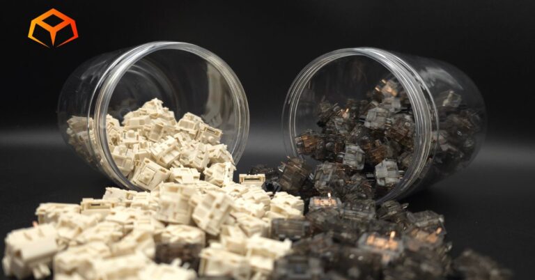 Close up shot of NovelKeys Cream and Gateron Ink Black switches spilling from jars