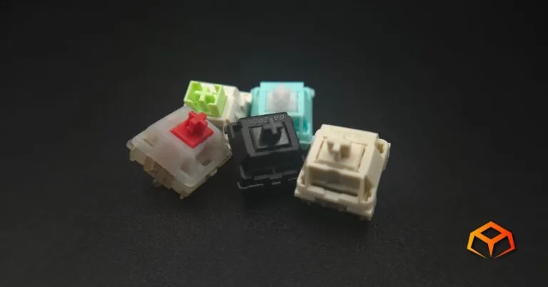 Macro shot of a single Gateron Oil King, Gateron Cream Soda, LEOBOG Reaper, Glorious Lynx, and NovelKeys Cream switches clumped together in the middle of the photo