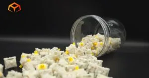 Close up shot of Gateron Milky Yellow Pro V3 switches spilling out of a jar