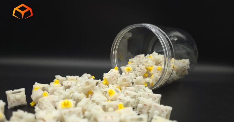 Close up shot of Gateron Milky Yellow Pro V3 switches spilling out of a jar