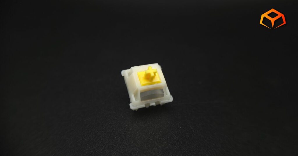 Macro shot of a single Gateron Milky Yellow Pro V3 switch with the logo visible