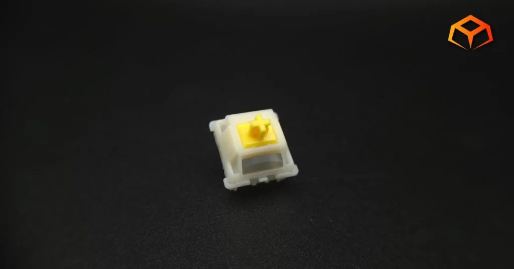Macro shot of a single Gateron Milky Yellow Pro V3 switch with the logo visible
