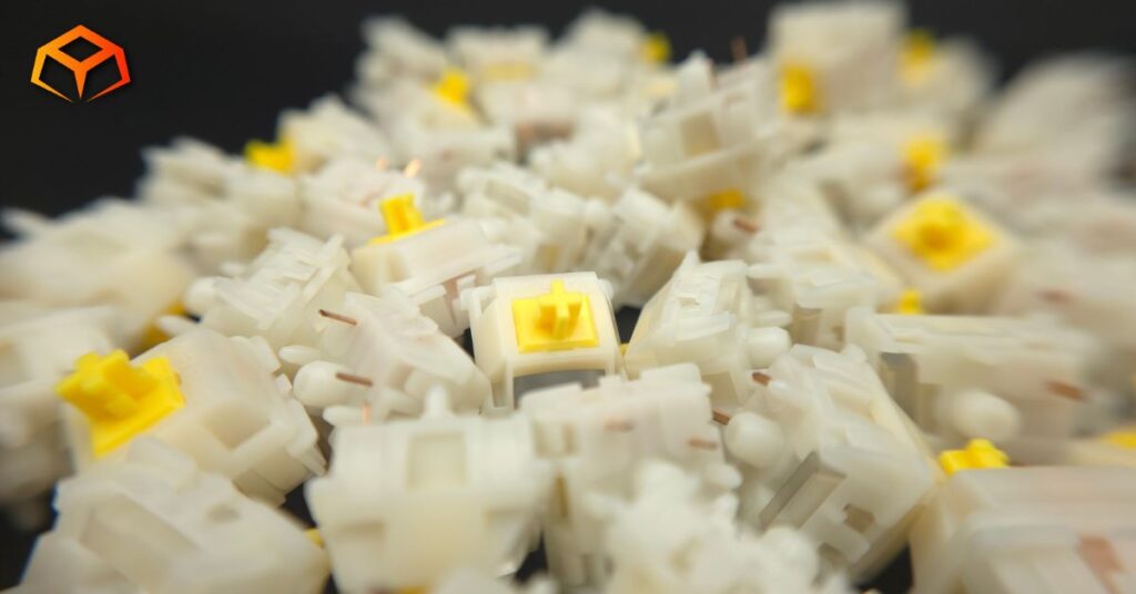 Macro shot of Gateron Milky Yellow Pro V3 switches piled on top of each other with focus on the switch in the center