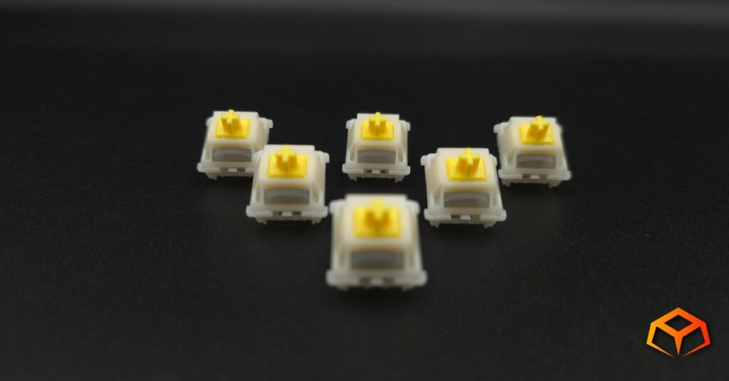 Close up shot of Gateron Milky Yellow Pro V3 switches in a triangle formation